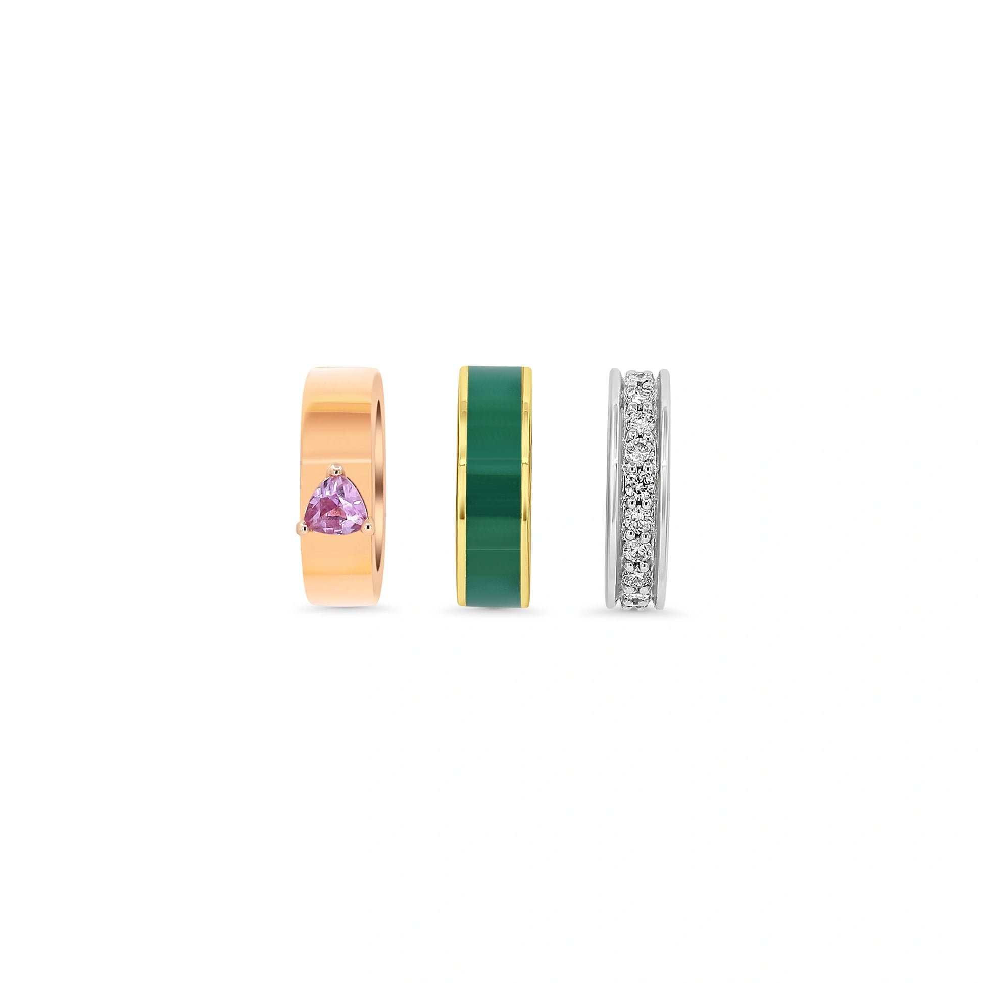 Three gold, green, and silver rings with gemstones on a white background