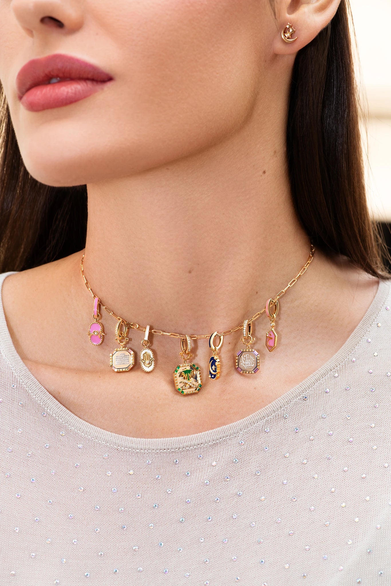 Necklace with various charms worn by a person