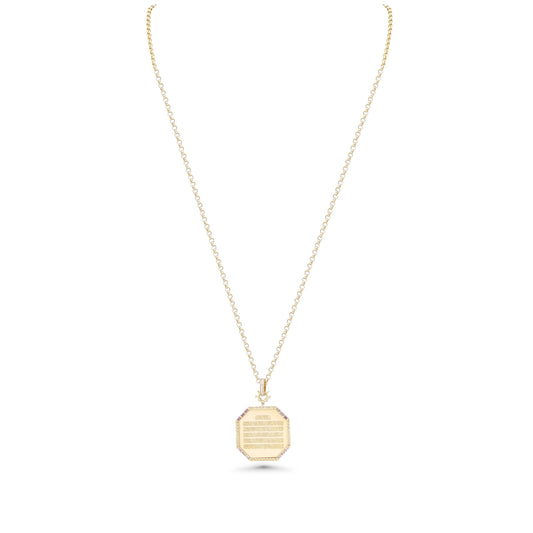 Gold necklace with a hexagonal pendant on a white background