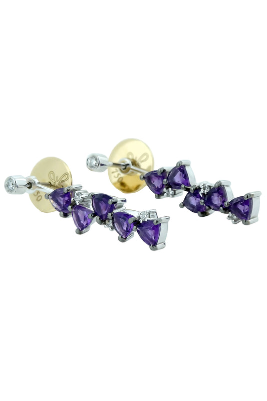 Pair of earrings with purple gemstones on a white background