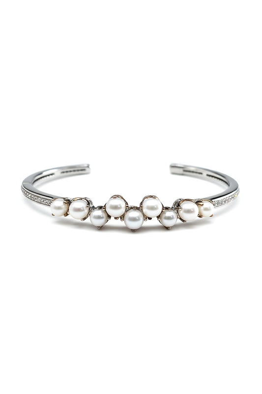 Silver bracelet with pearls on a white background